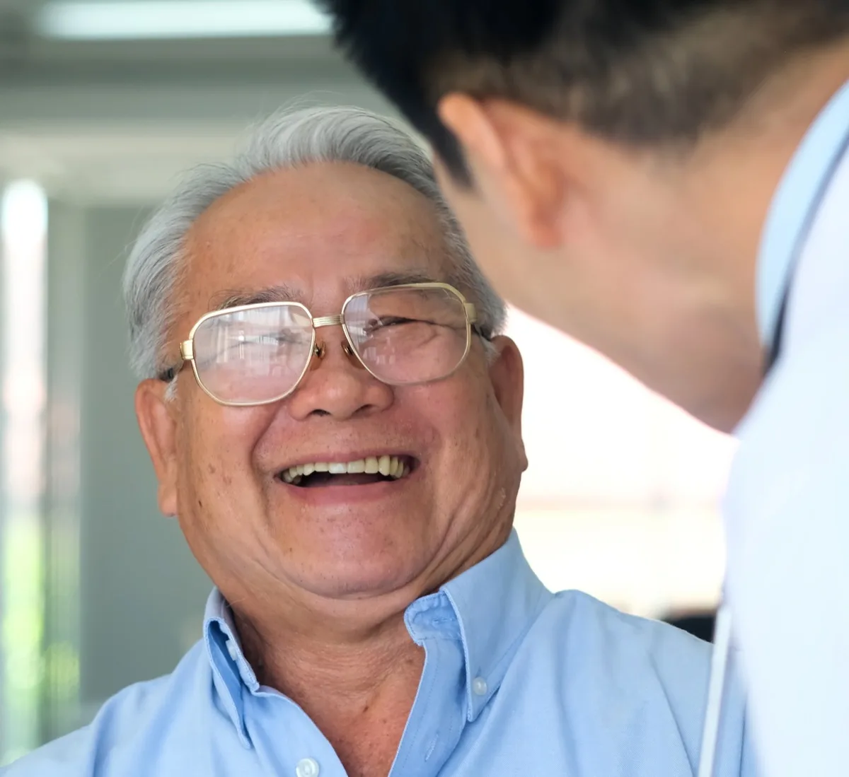 Portrait Happy Old man patient laugh with doctor when talk about cancer. The Healthy old man patient talk with doctor about health repot.
