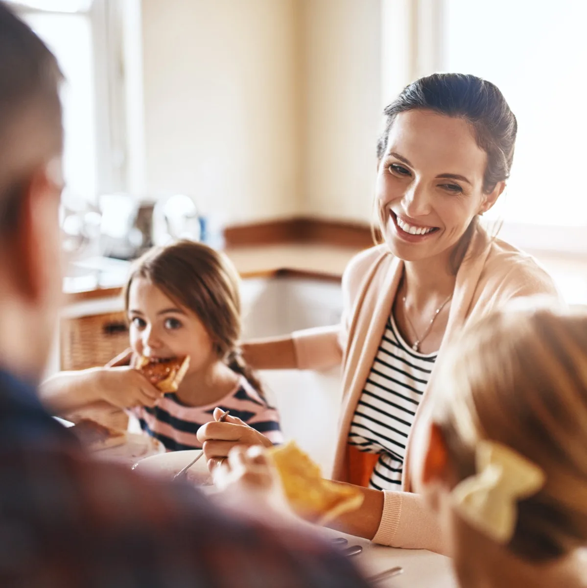 Woman, family and eating breakfast kitchen for bonding, love and care or healthy nutrition in morning of kid development. Parents, children and diet food, meal and lunch wellness growth at house